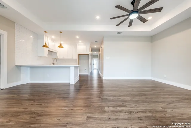 a view of a kitchen with a dishwasher and wooden floor