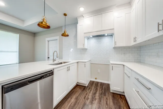 a kitchen with a sink a stove and cabinets