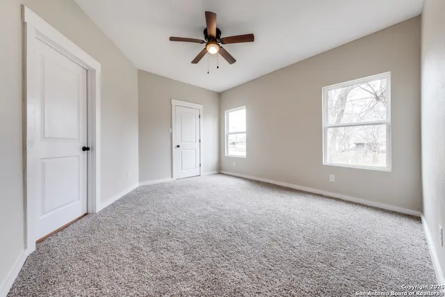 a view of empty room with ceiling fan