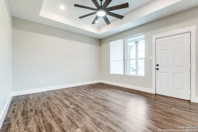 wooden floor in an empty room with a window