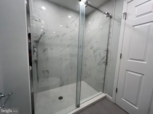 a bathroom with a glass shower door