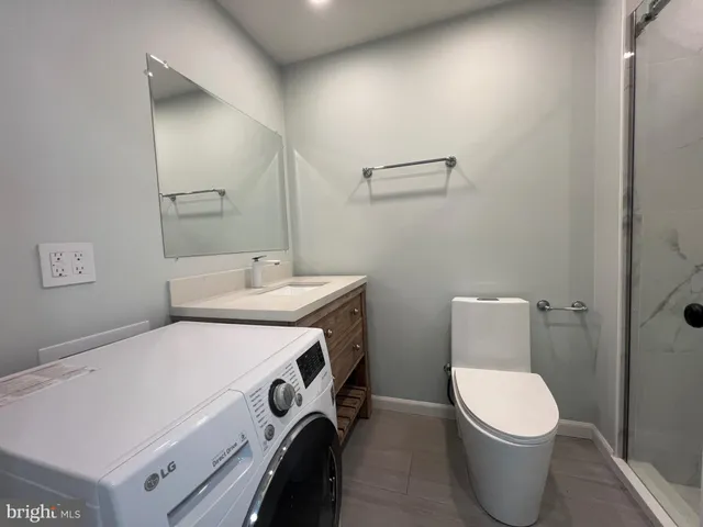 a bathroom with a toilet sink and mirror