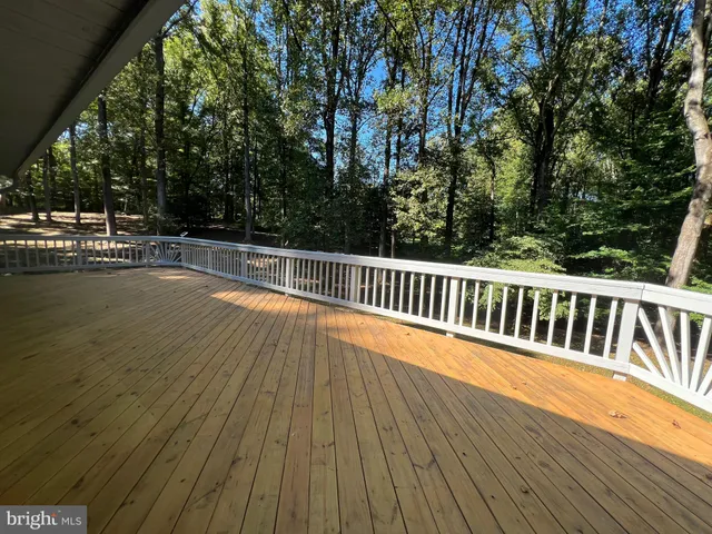 a view of balcony with wooden floor and fence