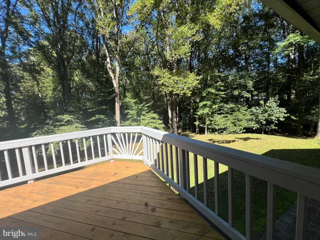 a view of balcony with wooden floor and fence