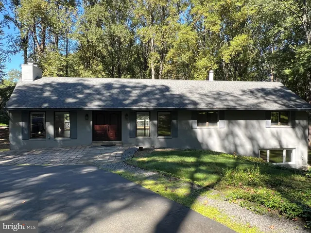 a view of a wooden house with a small yard