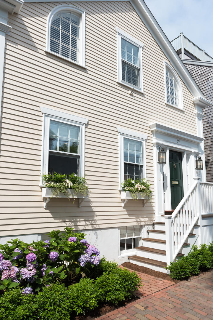 59 Orange Street Nantucket, MA 02554 - Photo 3 of 42 a front view of a house with a yard