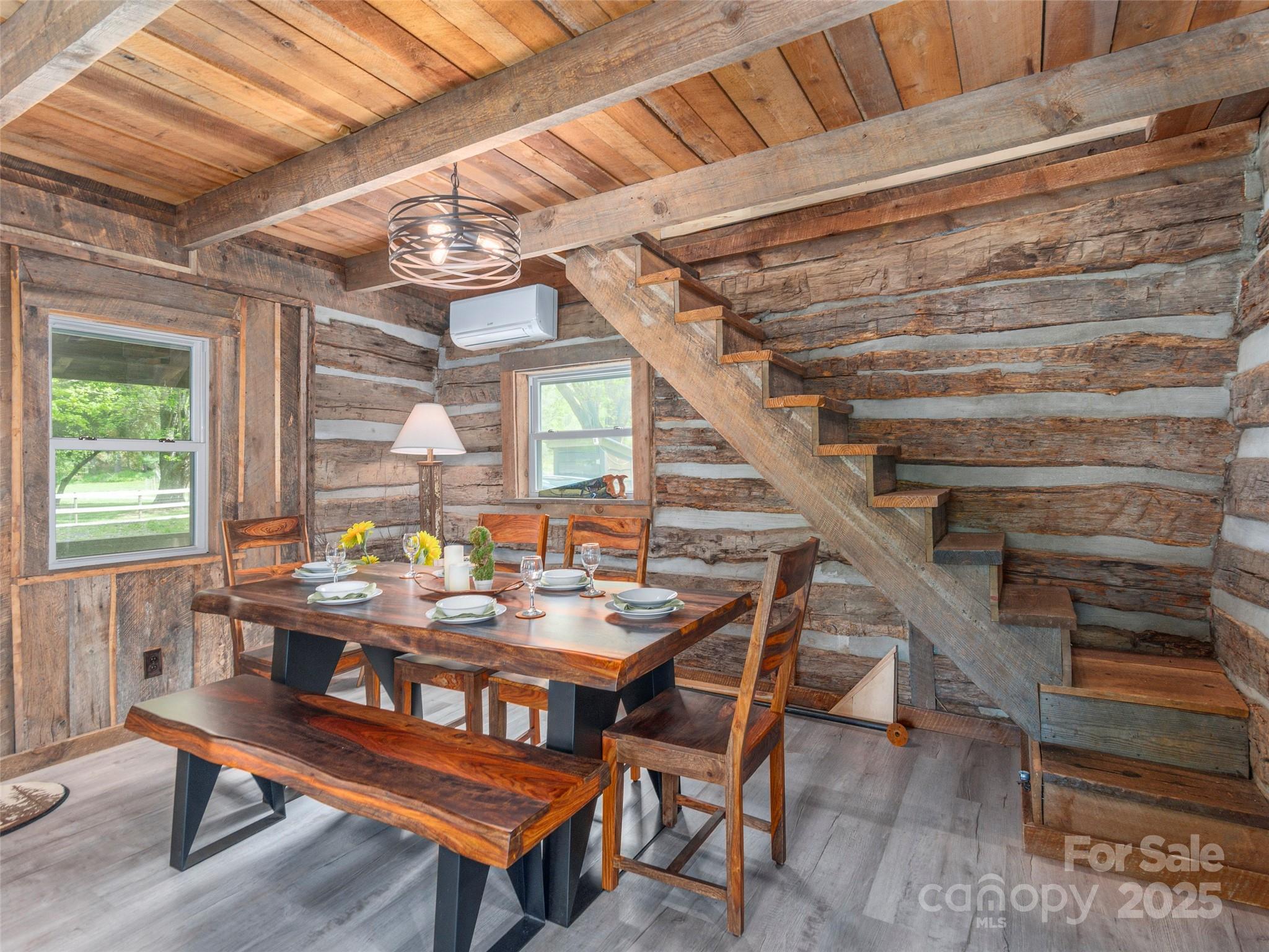 9386 Cruso Road Canton, NC 28716 - Photo 12 of 40 a dining room with furniture wooden floor and a potted plant
