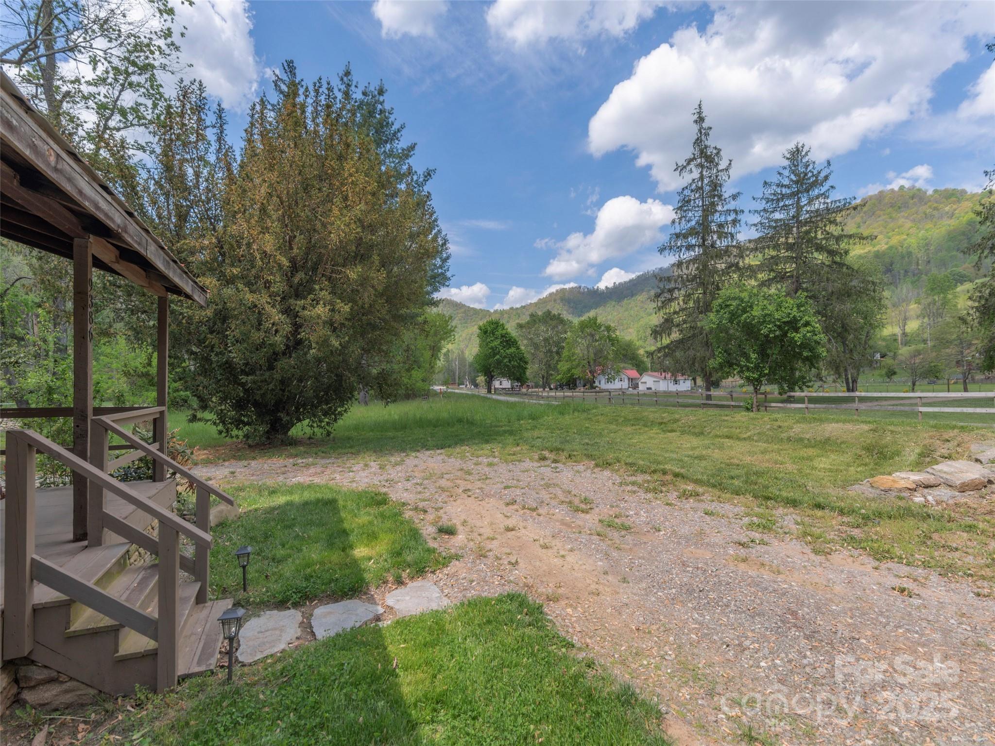 9386 Cruso Road Canton, NC 28716 - Photo 4 of 40 a view of a house with a backyard and a fountain