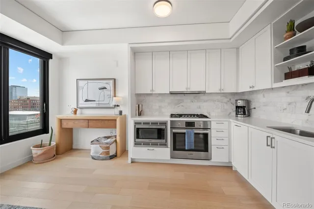 a kitchen with a stove top oven and sink