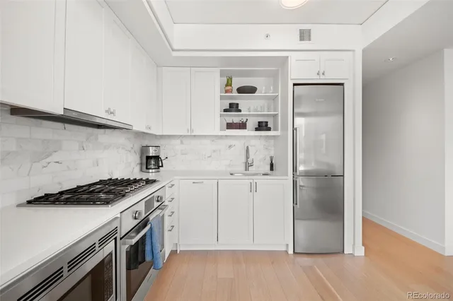 a kitchen with a sink a stove and refrigerator
