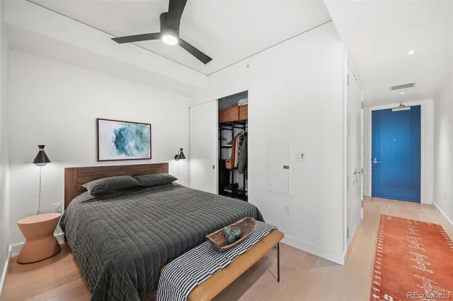 a bedroom with a large bed and a chandelier