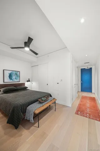a bedroom with a bed and a ceiling fan