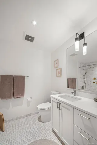 a bathroom with a toilet a sink and mirror