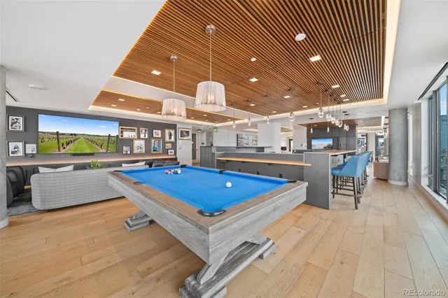 a living room with stainless steel appliances kitchen island granite countertop furniture and a kitchen view