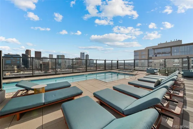 a view of a swimming pool with outdoor seating