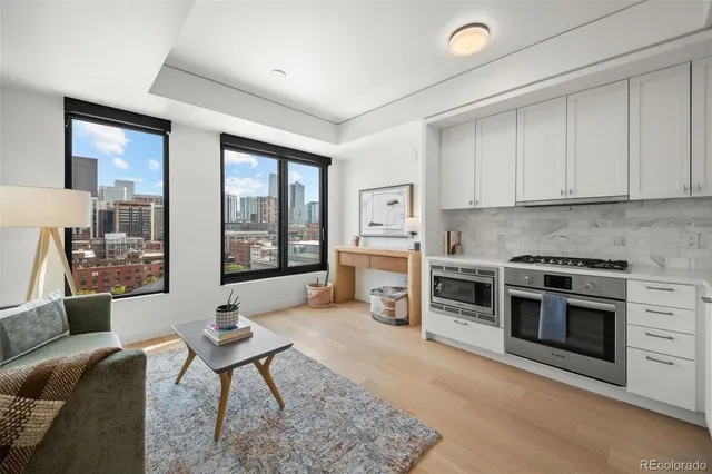 a living room with furniture a fireplace and a table