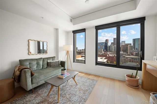 a living room with furniture and a floor to ceiling window