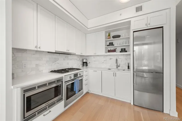 a kitchen with cabinets and stainless steel appliances