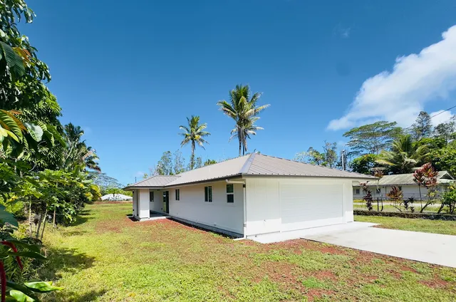 a view of a house with a yard and garage