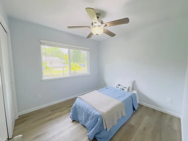 a bedroom with a bed and window