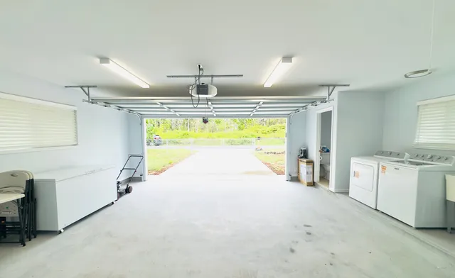 a large white kitchen with a large window