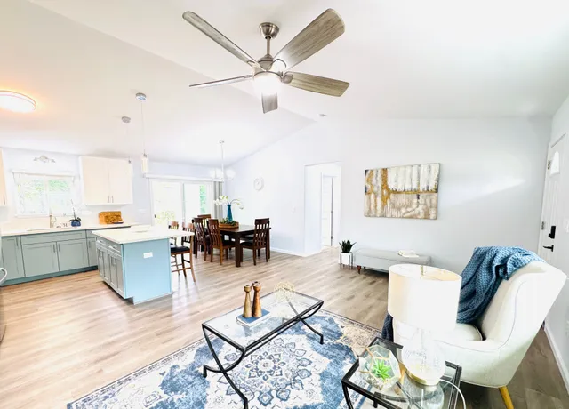 a living room with furniture and view of kitchen