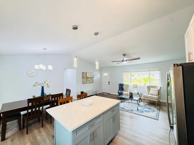 a large room with table chairs and flat screen tv