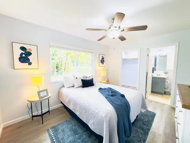 a spacious bedroom with a bed and a chandelier