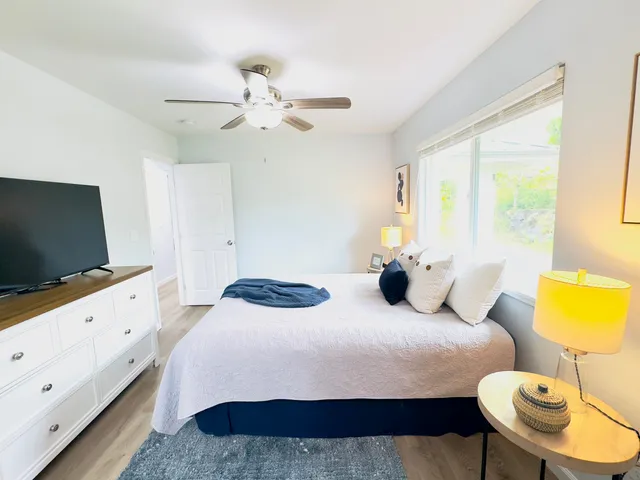 a bedroom with a bed and a flat screen tv