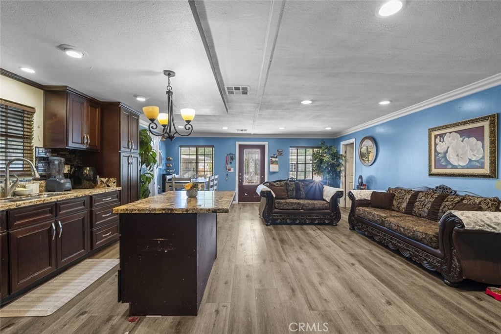 3255 East Avenue R, Unit 34 Palmdale, CA 93550 - Photo 11 of 32 a living room with furniture and a wooden floor