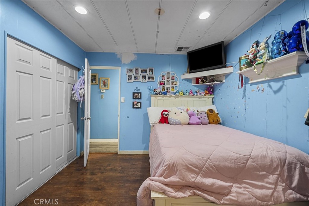 3255 East Avenue R, Unit 34 Palmdale, CA 93550 - Photo 15 of 32 a bedroom with a bed and flat screen tv