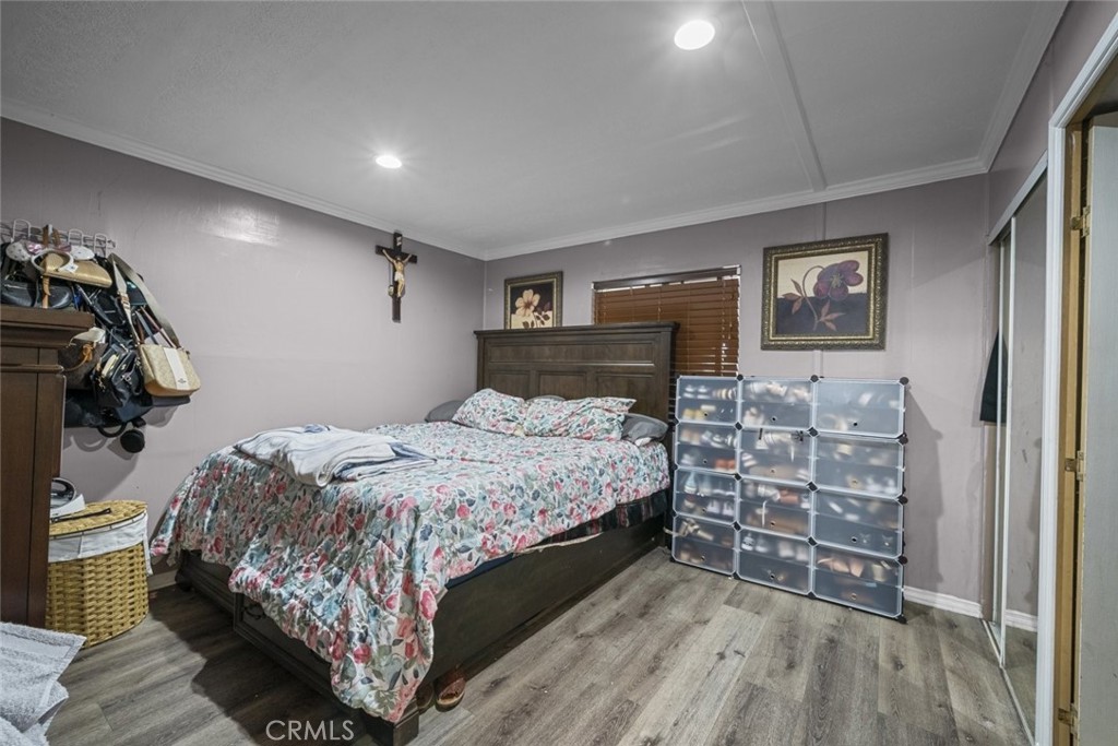 3255 East Avenue R, Unit 34 Palmdale, CA 93550 - Photo 17 of 32 a bedroom with a bed and a view of closet
