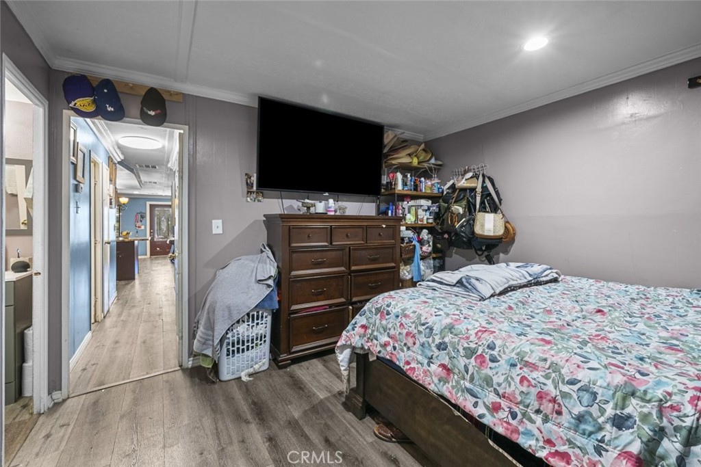 3255 East Avenue R, Unit 34 Palmdale, CA 93550 - Photo 18 of 32 a bedroom with a bed and a flat screen tv