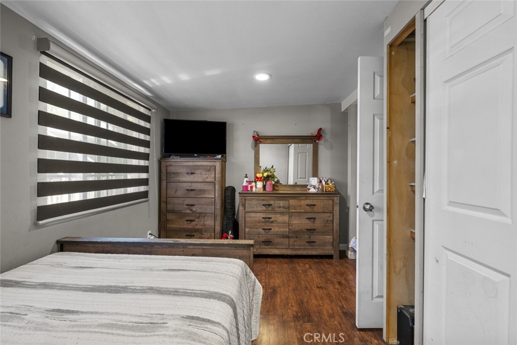 3255 East Avenue R, Unit 34 Palmdale, CA 93550 - Photo 27 of 32 a view of a bedroom with a bed and a flat screen tv