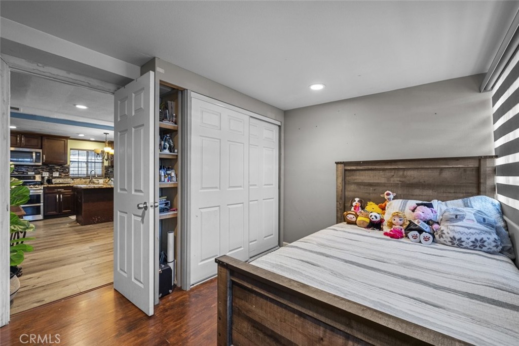 3255 East Avenue R, Unit 34 Palmdale, CA 93550 - Photo 28 of 32 a bed room with furniture and a view of kitchen