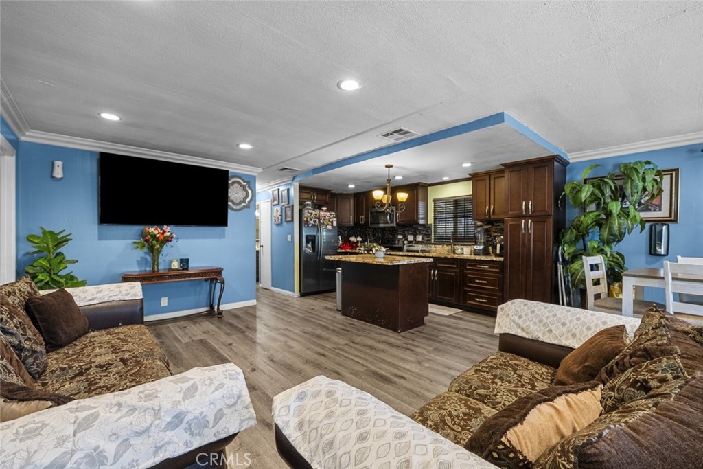 3255 East Avenue R, Unit 34 Palmdale, CA 93550 - Photo 4 of 32 a living room with furniture and a flat screen tv