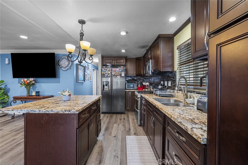 3255 East Avenue R, Unit 34 Palmdale, CA 93550 - Photo 6 of 32 a kitchen with granite countertop counter top space a sink appliances and cabinets