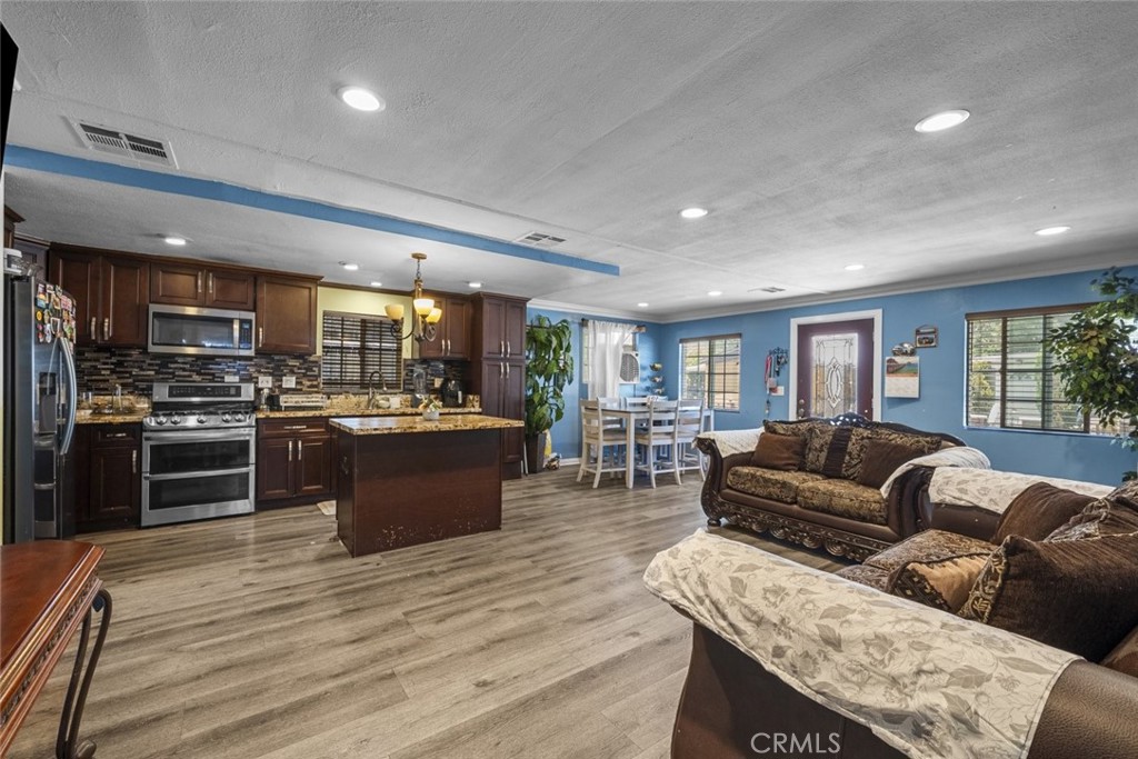 3255 East Avenue R, Unit 34 Palmdale, CA 93550 - Photo 10 of 32 a living room with stainless steel appliances furniture and a kitchen view