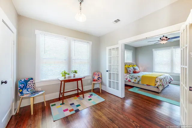 a bedroom with furniture and a wooden floor