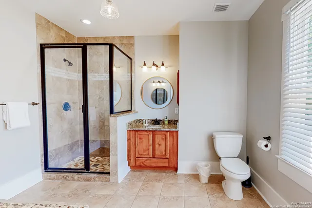 a bathroom with a toilet a sink and a mirror