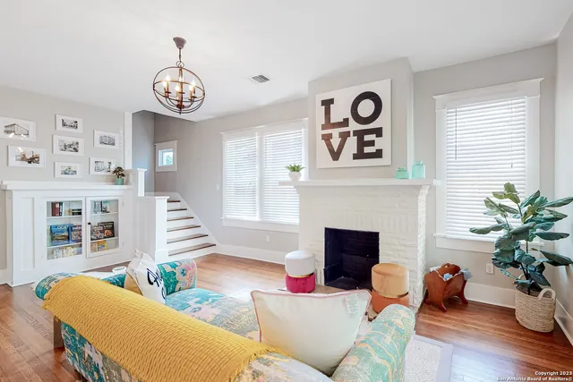 a living room with furniture and a fireplace