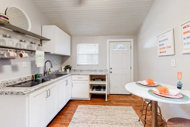 a kitchen with stainless steel appliances kitchen island granite countertop a sink and cabinets