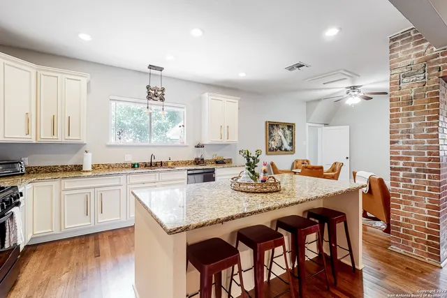 a kitchen with granite countertop stainless steel appliances a sink and cabinets