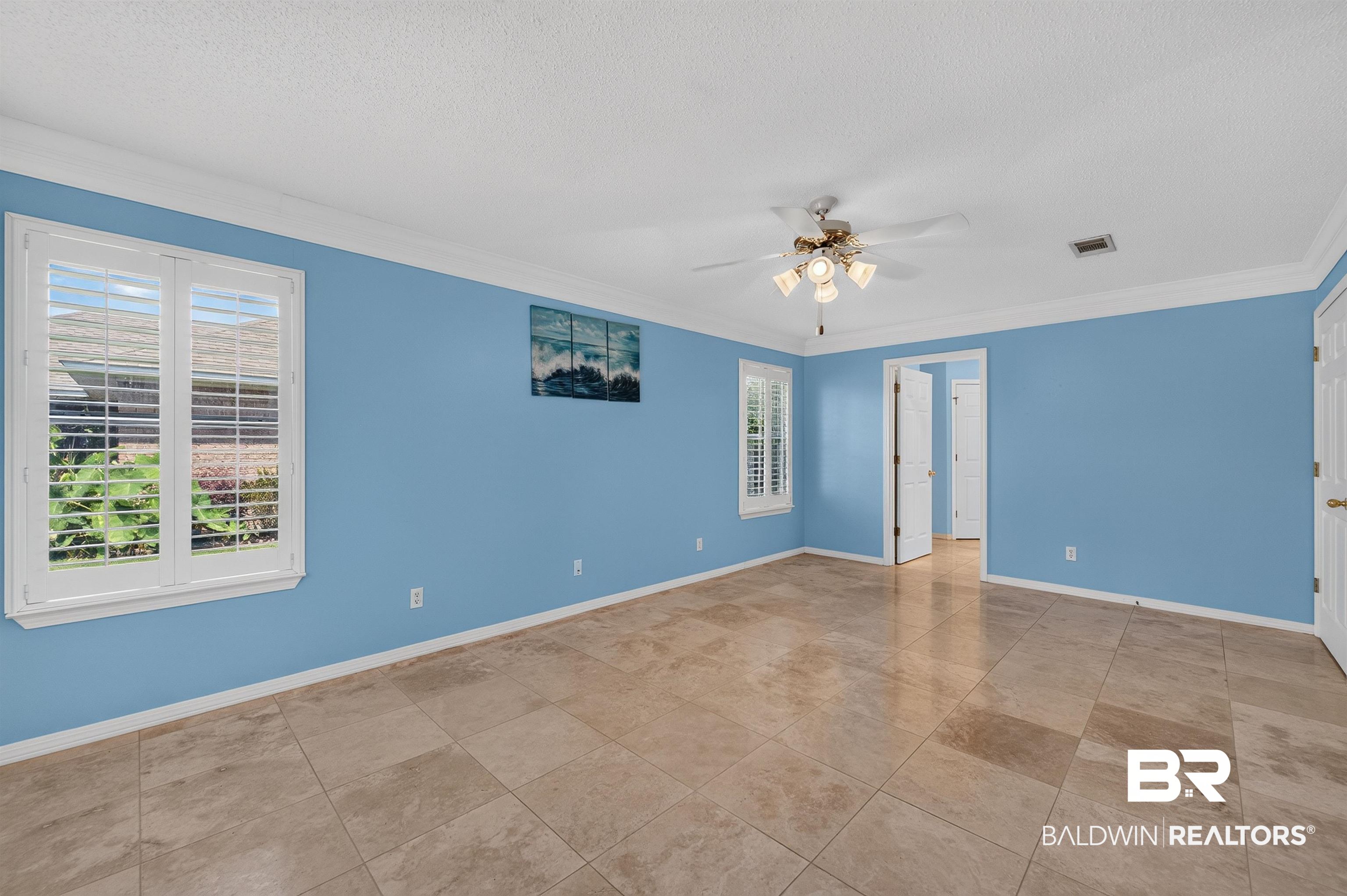 22685 County Road 12 Foley, AL 36535 - Photo 53 of 89 Spacious room featuring tile flooring, white crown molding, and a ceiling fan with integrated lighting