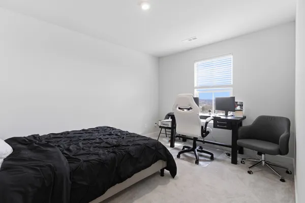 a bedroom with bed and chair