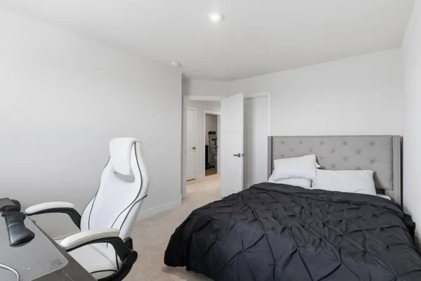 a bedroom with a bed and a desk
