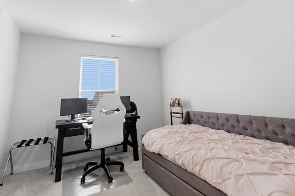 a bedroom with a bed and a chair