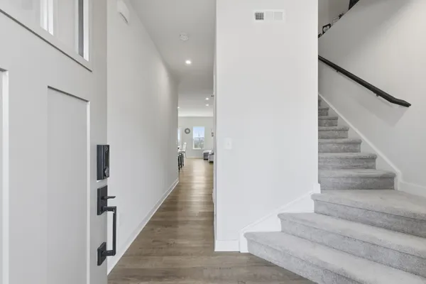 a view of entryway and hall with wooden floor