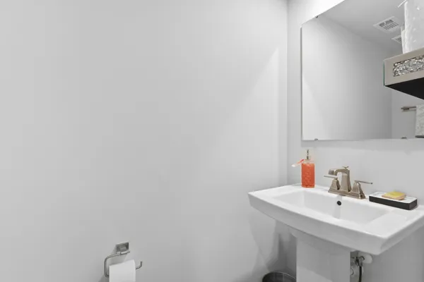 a kitchen with stainless steel appliances granite countertop a sink a stove a refrigerator and chairs