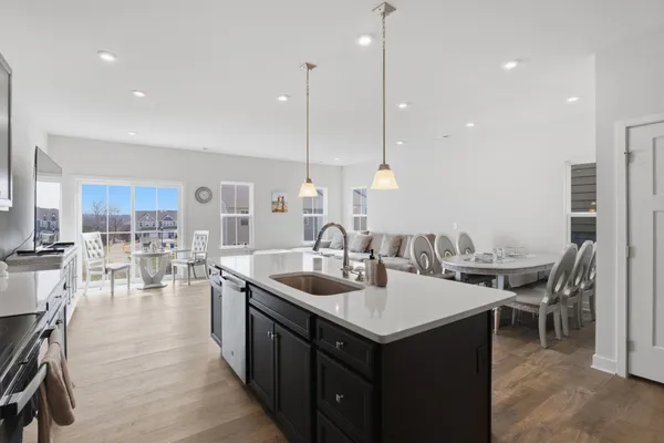 a kitchen with kitchen island granite countertop a sink stainless steel appliances and cabinets